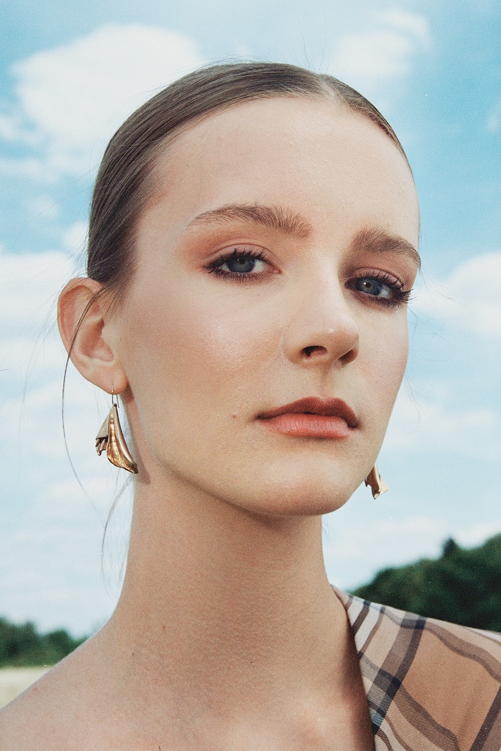 Woman wearing rose gold statement earrings